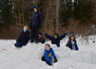 Boys on top of their snow structure